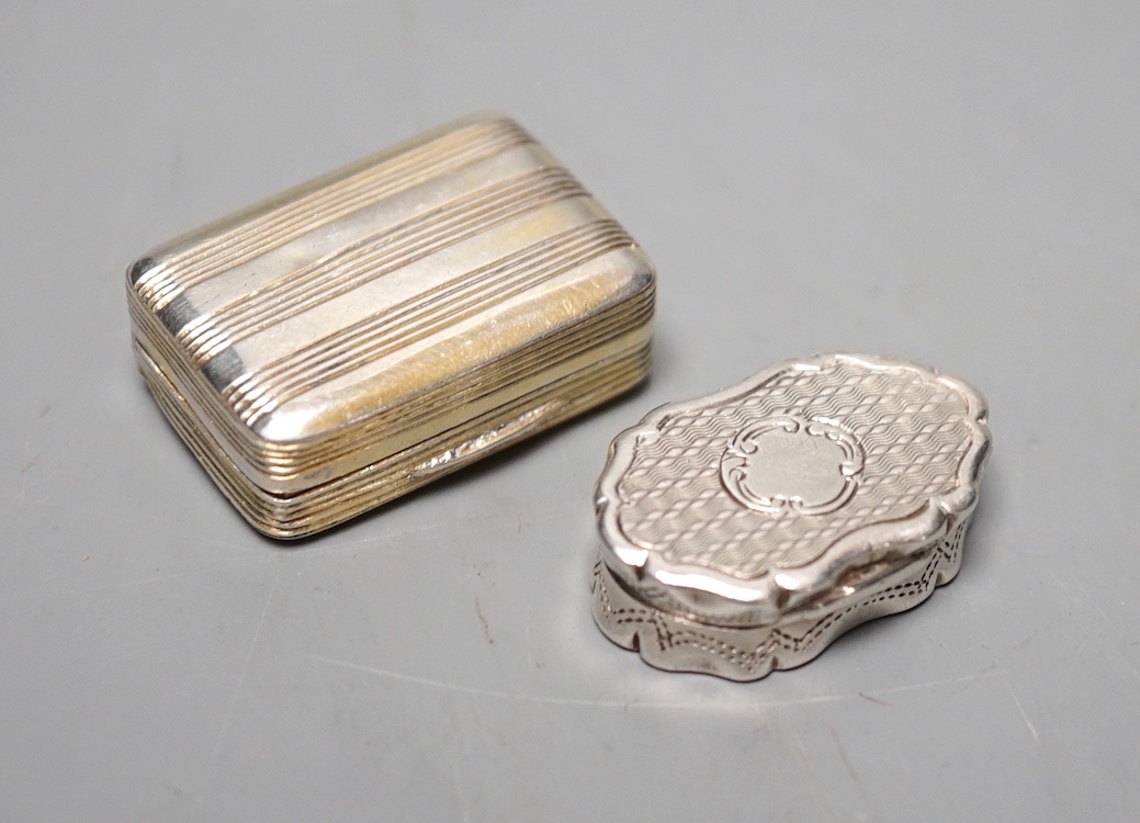 A George III silver gilt vinaigrette, TB, London, 1801, 30mm and a late shaped oval silver vinaigrette by George Unite, 27mm.